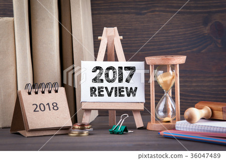 2017 review. Sandglass, hourglass or egg timer on wooden table  36047489