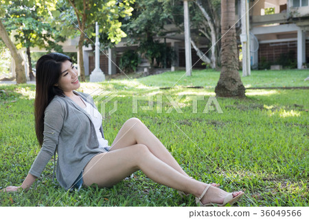 asian woman portrait. young female adult with natural make-up relax in park. attractive teenager smile with happiness in garden asian woman portrait. young female adult with natural make-up relax in park. attractive teenager smile with happiness in garden 36049566