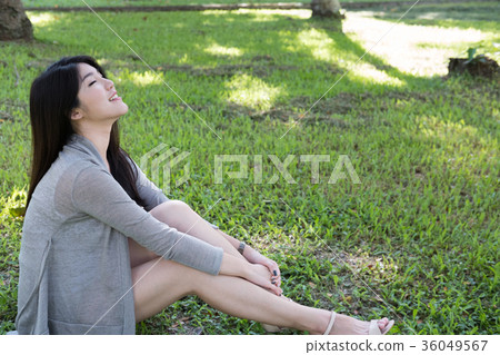 asian woman portrait. young female adult with natural make-up relax in park. attractive teenager smile with happiness in garden asian woman portrait. young female adult with natural make-up relax in park. attractive teenager smile with happiness in garden 36049567