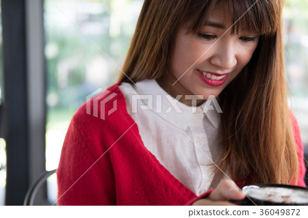 woman wear red sweater at restaurant. girl hold latte coffee cup at cafe woman wear red sweater at restaurant. girl hold latte coffee cup at cafe 36049872