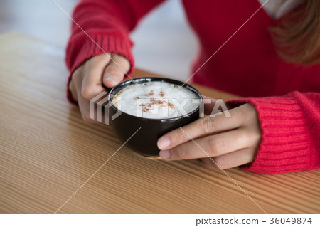 woman wear red sweater at restaurant. girl hold latte coffee cup at cafe woman wear red sweater at restaurant. girl hold latte coffee cup at cafe 36049874