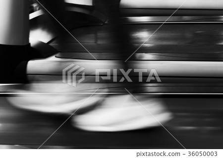 young woman execute exercise in fitness center. female athlete walking on treadmill in gym. sporty girl working out in health club. motion blur image 36050003