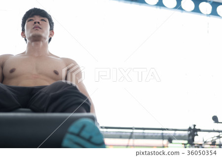 young man execute exercise with weightlifting machine in fitness center. male athlete pump up leg muscle in gym. sporty guy working out in health club. young man execute exercise with weightlifting machine in fitness center. male athlete pump up leg muscle in gym. sporty guy working out in health club. 36050354