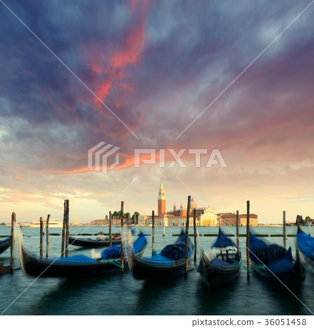 Row of gondolas parked on city pier 36051458
