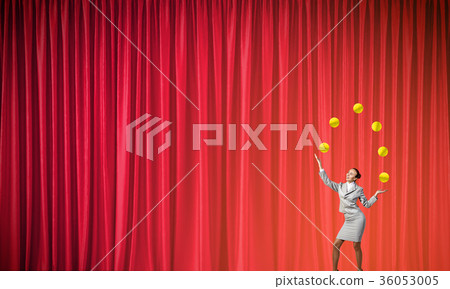 Businesswoman juggling with balls Businesswoman juggling with balls 36053005