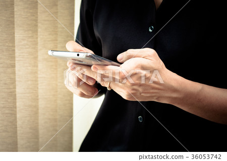 Close-up of hands using smartphones 36053742