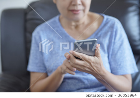 senior woman using mobile phone making a senior woman using mobile phone making a 36053964