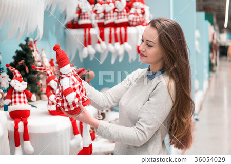 customer girl choosing gifts for Christmas and New 36054029