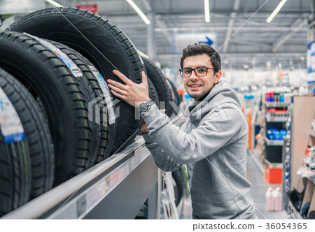 male customer choosing new tires 36054365