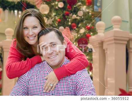 Caucasian Couple Hugging Near Christmas Tree. 36055912