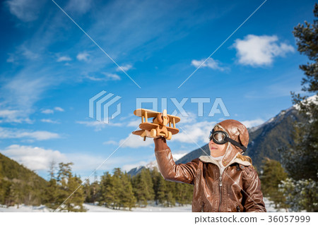 Happy child playing with toy airplane 36057999