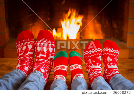 Family in Christmas socks near fireplace Family in Christmas socks near fireplace 36058273