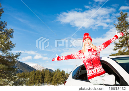 Happy woman travel by car in winter 36058482