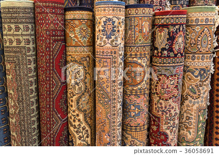 Colorful rolled carpets in oriental marketplace Colorful rolled carpets in oriental marketplace 36058691