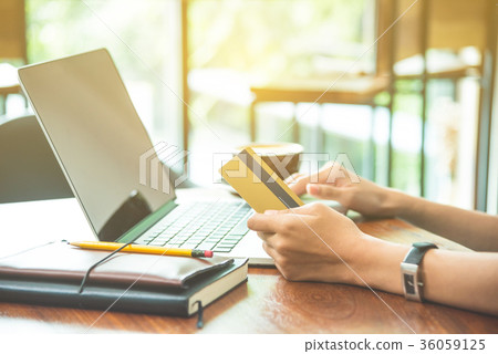 Woman buying goods online via laptop computer  36059125