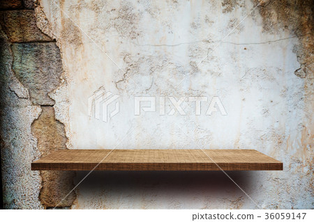 Empty wooden shelves display on cracked brick wall Empty wooden shelves display on cracked brick wall 36059147