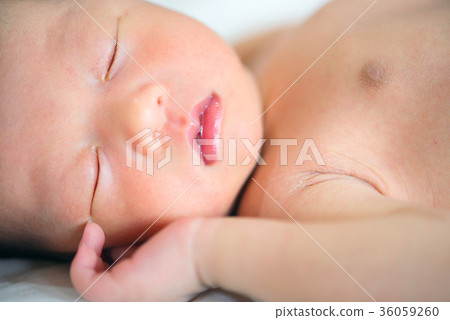 Close up new born baby sleeping 36059260