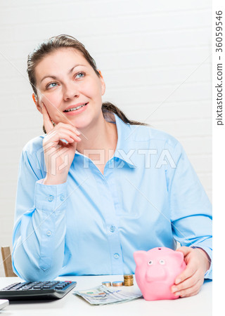 Dreamed successful businesswoman with a piggy bank 36059546