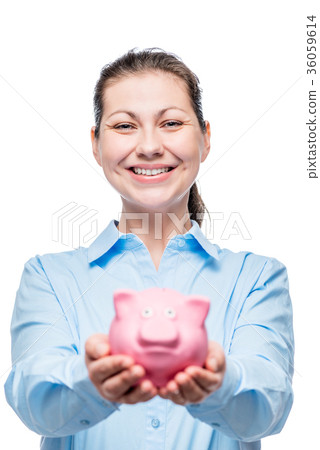 Happy woman holds a piggy bank full of money 36059614