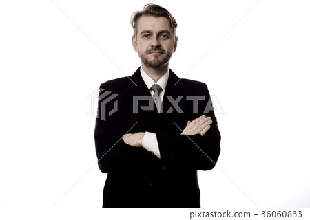 Smiling businessman standing with arms folded Smiling businessman standing with arms folded 36060833