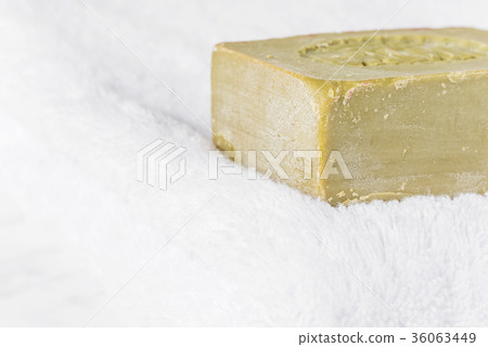 Organic olive soap on the white terry towel 36063449