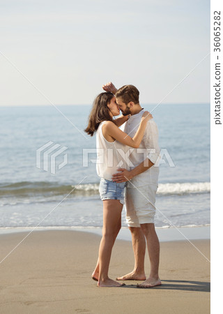 Romantic young couple on the beach kissing. Romantic young couple on the beach kissing. 36065282