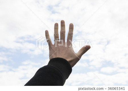 Male hand holding hand to sky 36065341