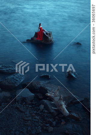 Lonely woman near the sea 36065697