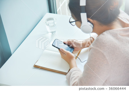 Asian woman listening to the music. 36066444