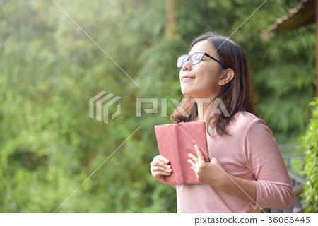 Happy Beautiful Asian woman holding book. 36066445