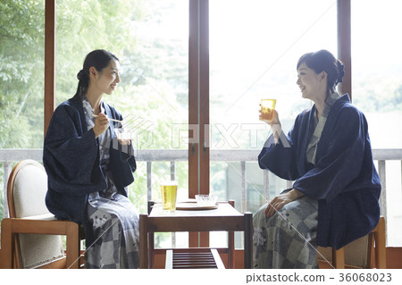 A woman drinking beer at an inn A woman drinking beer at an inn 36068023