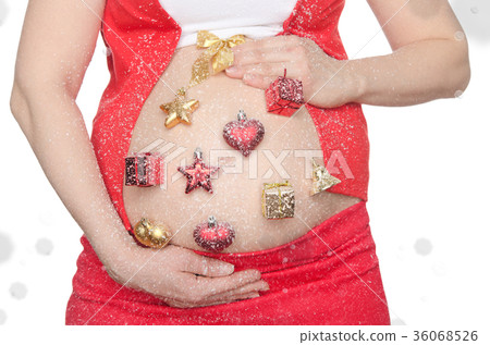 Belly of pregnant woman with Christmas decorations 36068526