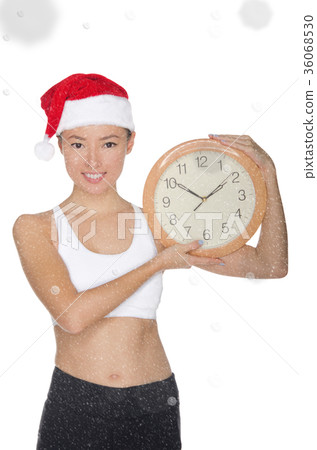 smiling asian women in a Santa's hat with a clock 36068530