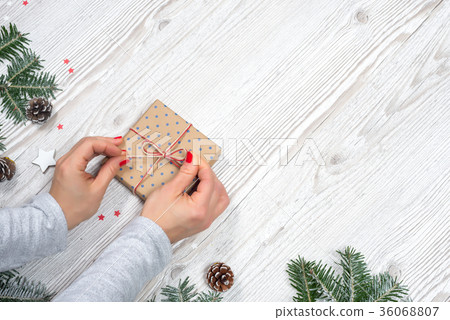 Gift box in hands with Christmas background 36068807