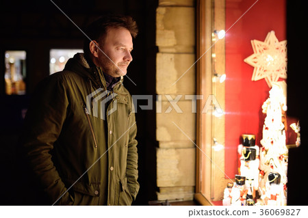 man looking on Xmas toys on Christmas market  36069827