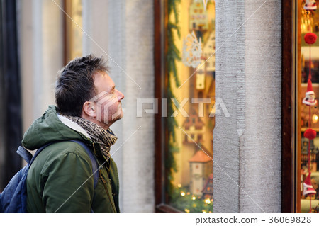 Middle age man looking on Xmas toys  36069828