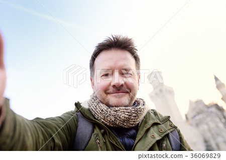 man making a self portrait with Neuschwanstein 36069829
