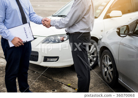 Customer shake hand with auto insurance agents after agreeing to Customer shake hand with auto insurance agents after agreeing to 36070068