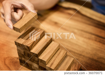 Business man hand put wooden blocks arranging stacking for devel Business man hand put wooden blocks arranging stacking for devel 36070071