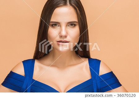 Beautiful young brunette woman posing in a blue Beautiful young brunette woman posing in a blue 36070120