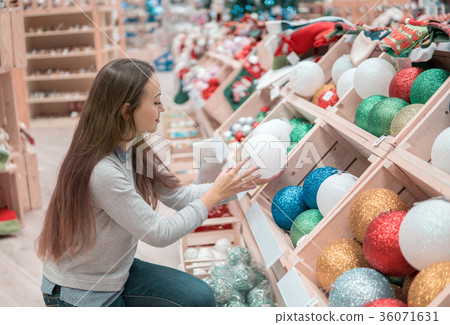 customer girl choosing gifts for Christmas and New customer girl choosing gifts for Christmas and New 36071631