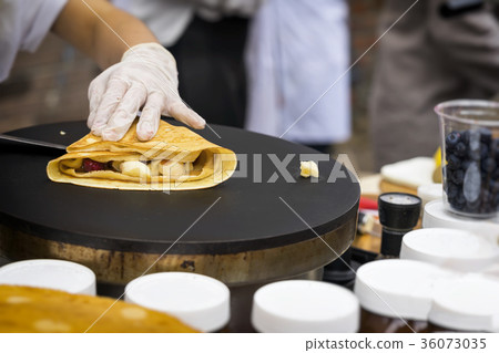 Close-up of hands of cook in gloves preparing 36073035