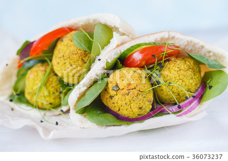 Baked falafel and fresh vegetables in pita bread Baked falafel and fresh vegetables in pita bread 36073237