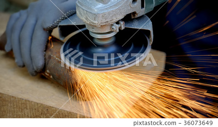 Worker cutting metal with grinder Worker cutting metal with grinder 36073649
