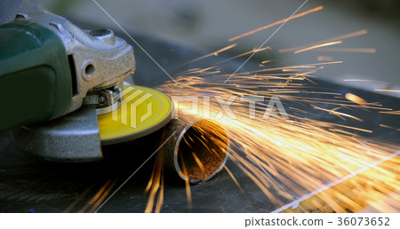 Worker cutting metal with grinder Worker cutting metal with grinder 36073652