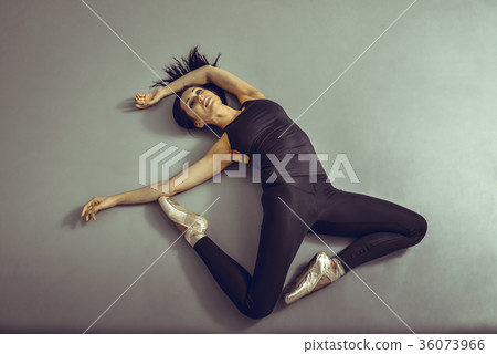 Young woman ballerina lying on the floor without Young woman ballerina lying on the floor without 36073966