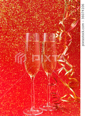Champagne flutes on red holiday background 36074106