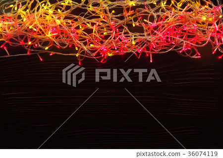 Christmas lights border on dark background Christmas lights border on dark background 36074119