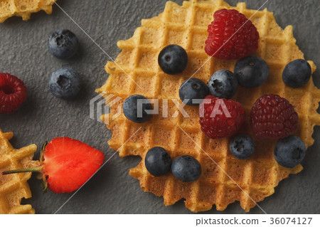 Round belgium waffles with berries Round belgium waffles with berries 36074127