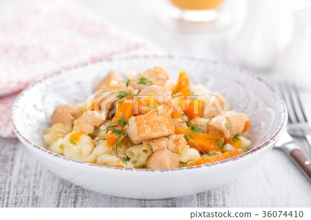 Braised chicken with carrot in sauce and pasta 36074410